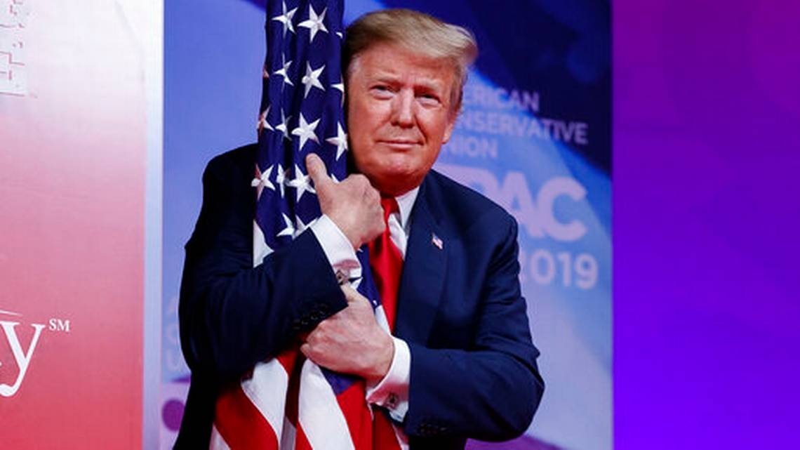Mr. Trump hugs the flag